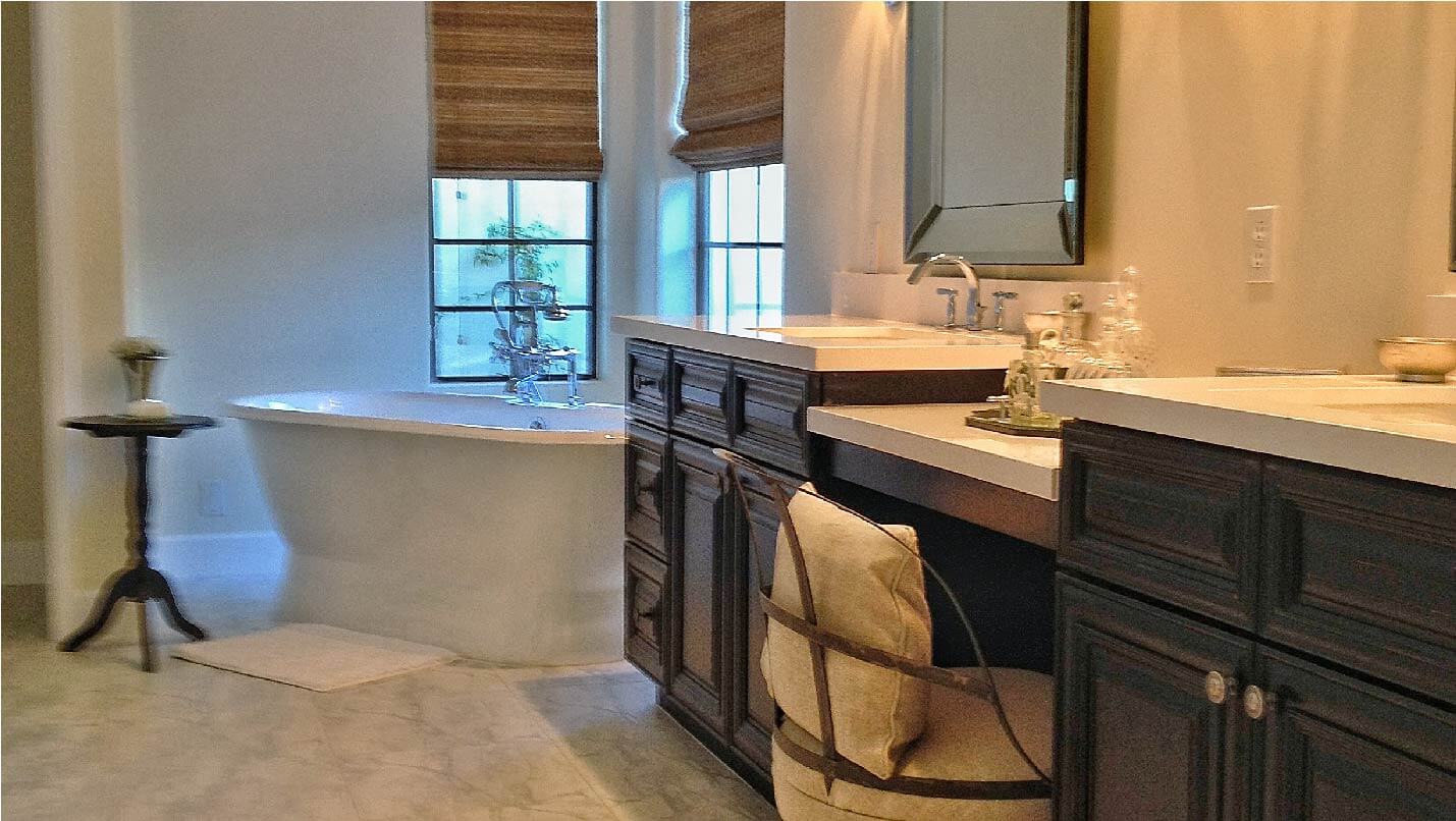 Bathroom with white tub and wooden cabinets